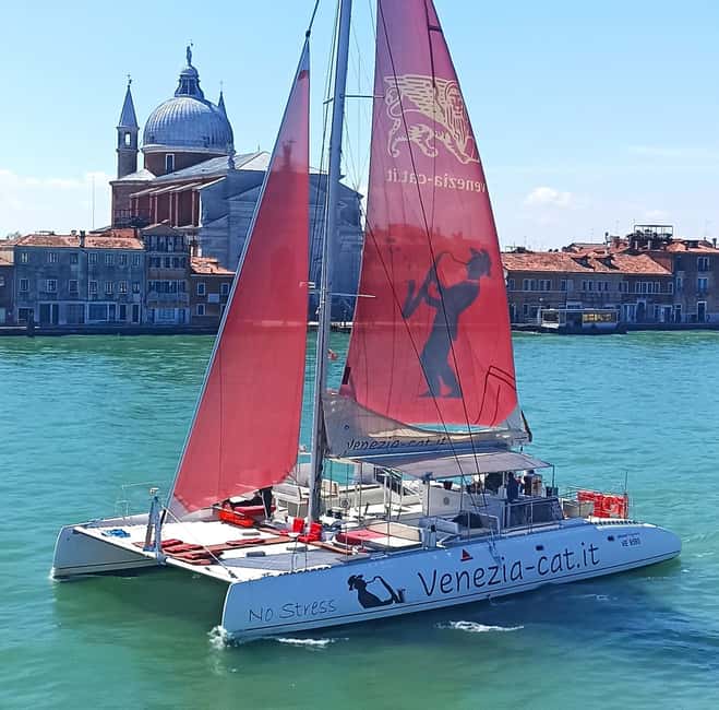 Venice: Lagoon Catamaran Tour with Classical Music & Drinks - Finding the Red Sails at Riva dei Sette Martiri